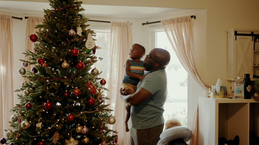 Glen & Uzi Henry admiring their family Christmas tree during the holidays.